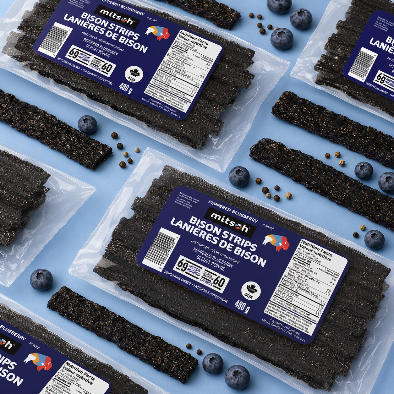 Peppered Blueberry Bison Pemmican bulk packs arranged with blueberries, pepper and pemmican strips