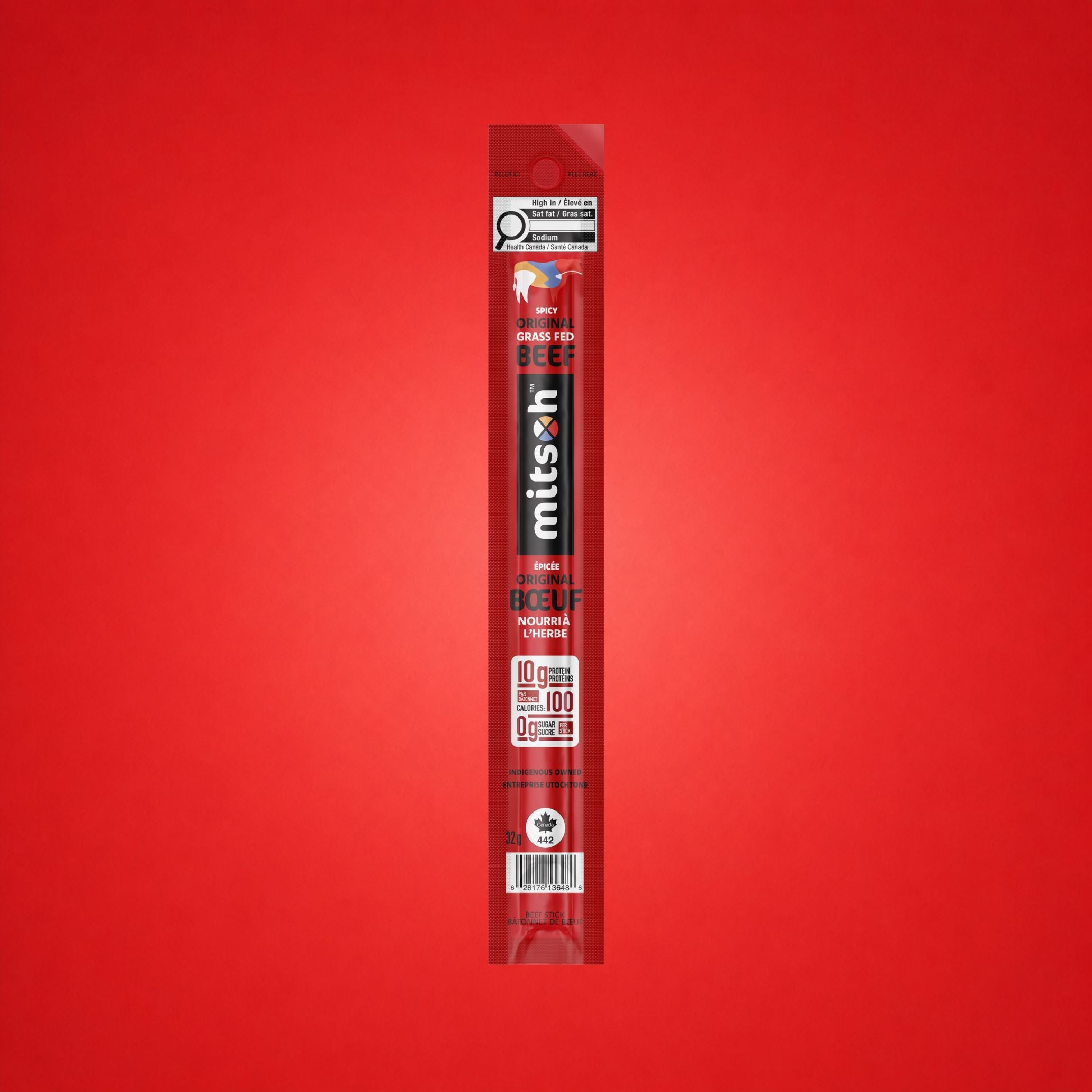 Single Spicy Original Grass-Fed Beef Stick on a red background